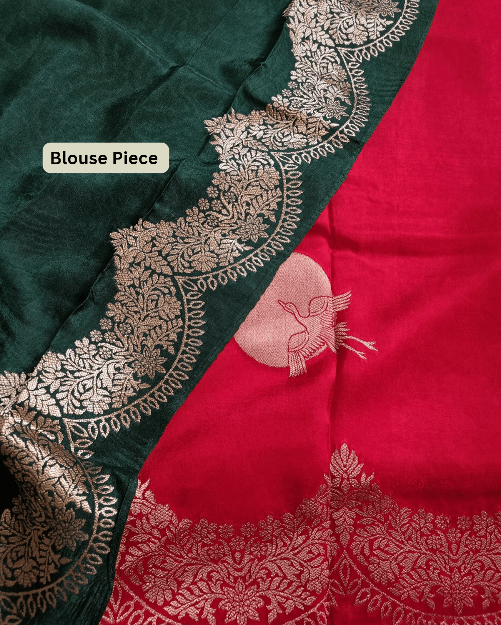 Banarasi Satin Crepe Silk in Deep Red shade with bird motifs weaves all over the body. Very unique motifs with scallop Design woven in border.It includes plain blouse piece with border in bold and contrast Dark Green shade that pairs beautifully the saree and lifts the overall look.