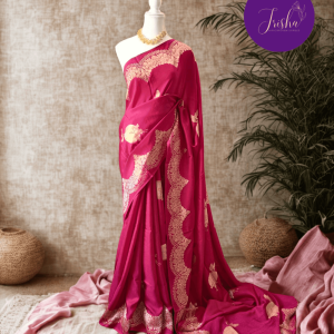 Banarasi Satin Crepe Silk in Rich Rani Pink shade with bird motifs weaves all over the body. Very unique motifs with scallop Design woven in border.It includes plain blouse piece with border in bold and contrast Rust Orange shade that pairs beautifully the saree and lifts the overall look.