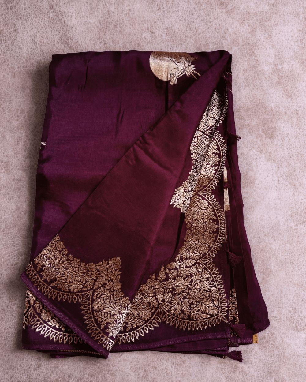 Banarasi Satin Crepe Silk in Wine shade with bird motifs weaves all over the body. Very unique motifs with scallop Design woven in border.It includes plain blouse piece with border in bold and contrast Yellow shade that pairs beautifully the saree and lifts the overall look.