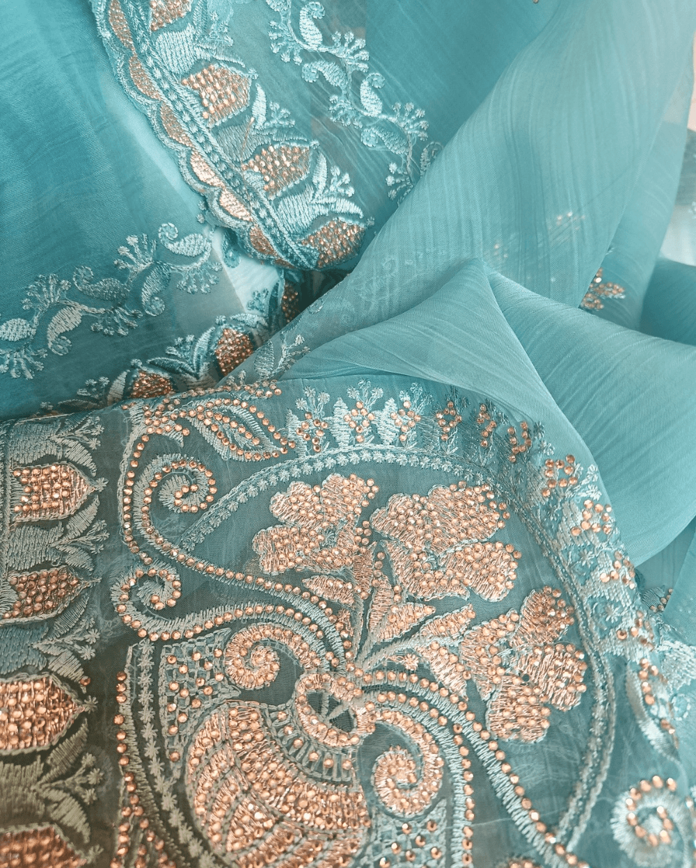 Light Blue Tone with self shade thread embroidery and diamond stone work Chiffon saree. Border throughout the saree and Pallu has rich embroidery and diamond work .The Pallu is beautifully done in a C shape work pattern. The shade has a very pleasant look and and the light embellishments give a complete twist to the subtle look of the saree. Blouse Piece comes with beautiful back design with embroidery and stone work done