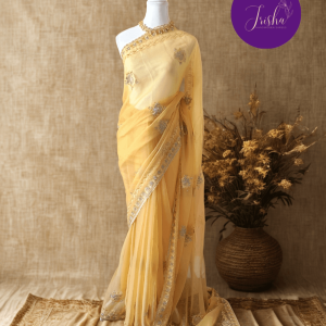 Light Butter Yellow Tone with self shade thread embroidery and diamond stone work Chiffon saree. Border throughout the saree and Pallu has rich embroidery and diamond work .The Pallu is beautifully done in a C shape work pattern. The shade has a very pleasant look and and the light embellishments give a complete twist to the subtle look of the saree. Blouse Piece comes with beautiful back design with embroidery and stone work done