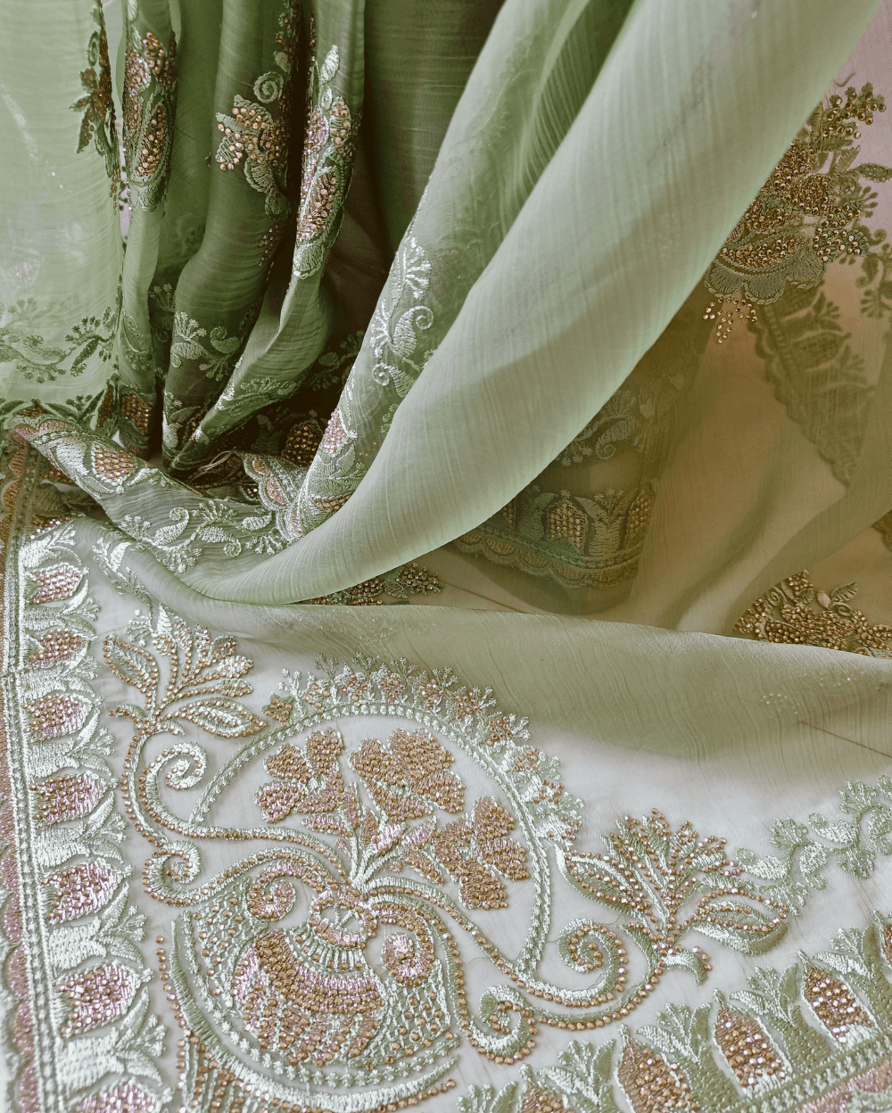 Green Tone with self shade thread embroidery and diamond stone work Chiffon saree. Border throughout the saree and Pallu has rich embroidery and diamond work .The Pallu is beautifully done in a C shape work pattern. The shade has a very pleasant look and and the light embellishments give a complete twist to the subtle look of the saree. Blouse Piece comes with beautiful back design with embroidery and stone work done.