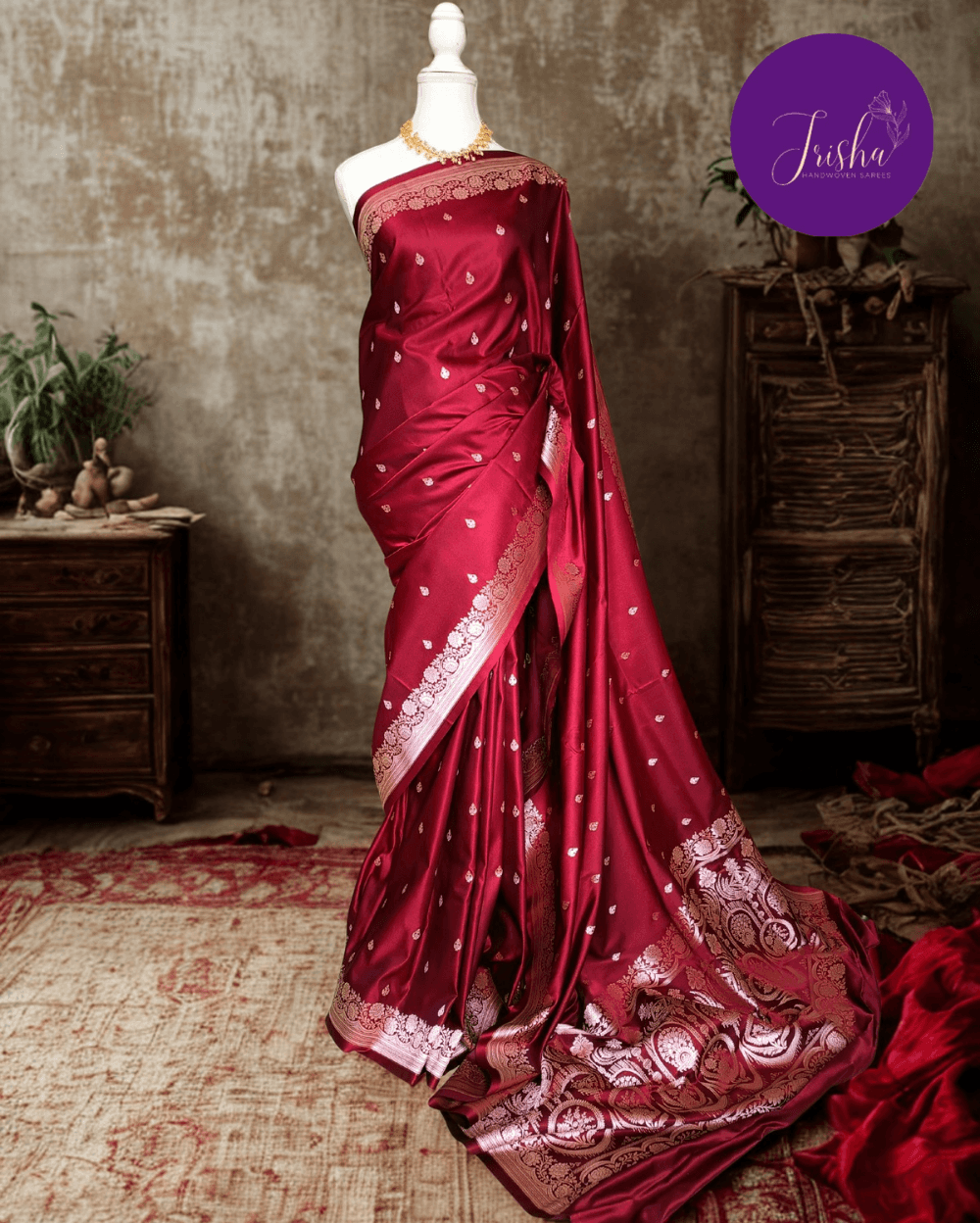 Banarasi Mashru Katan Silk saree in Deep Maroon with small buttis all over the saree. The Rose Gold zari makes the finish very royal and elegant. Saree has a very beautiful traditional border and a very rich pallu that makes the usage of this saree suit any occasion or formal wear. The Pallu is attractively designed and woven with intricate Banarasi floral motifs.