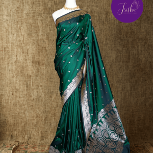 Banarasi Mashru Katan Silk saree in Green shade with small buttis all over the saree. The Rose Gold zari makes the finish very royal and elegant. Saree has a very beautiful traditional border and a very rich pallu that makes the usage of this saree suit any occasion or formal wear. The Pallu is attractively designed and woven with intricate Banarasi floral motifs.