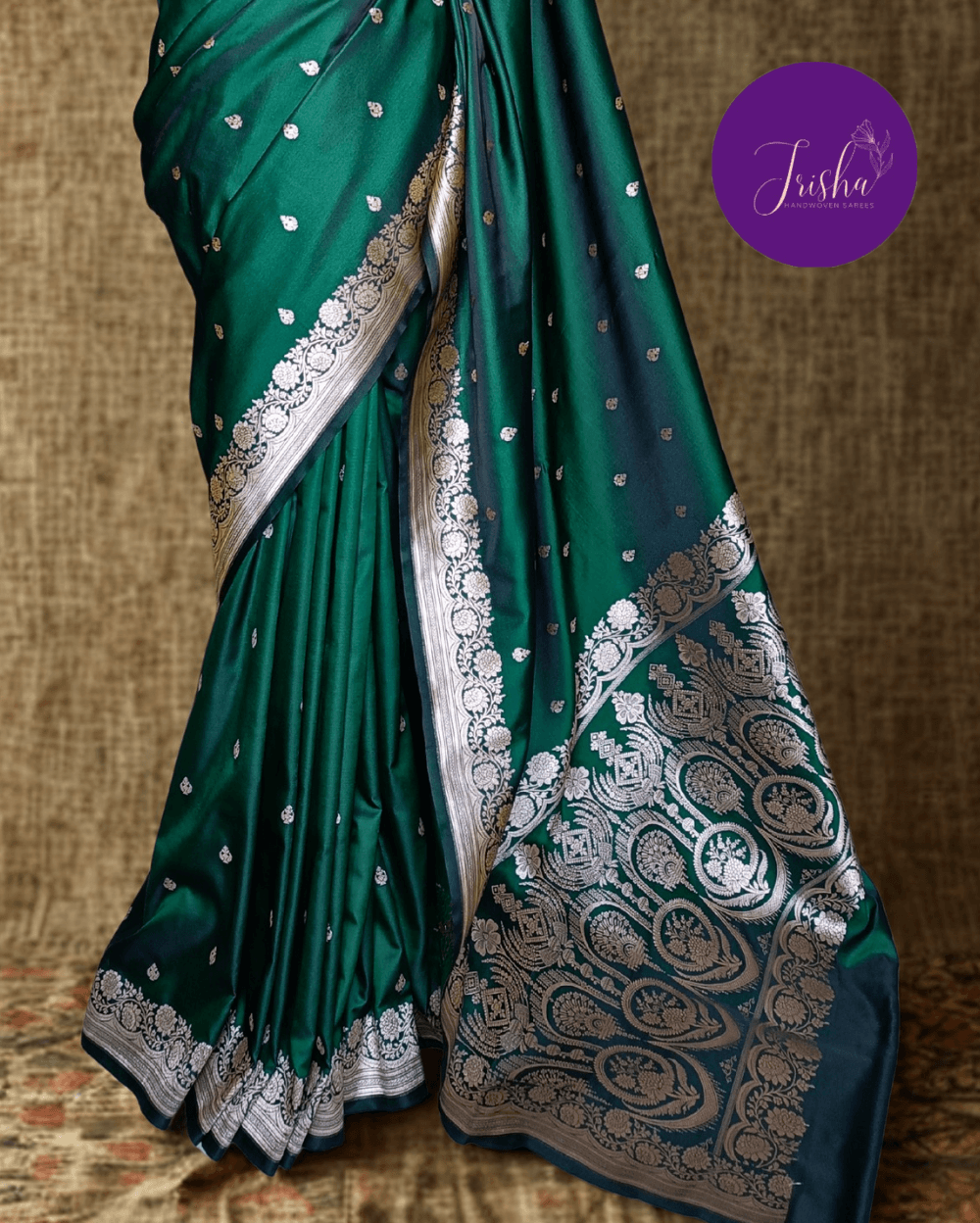 Banarasi Mashru Katan Silk saree in Green shade with small buttis all over the saree. The Rose Gold zari makes the finish very royal and elegant. Saree has a very beautiful traditional border and a very rich pallu that makes the usage of this saree suit any occasion or formal wear. The Pallu is attractively designed and woven with intricate Banarasi floral motifs.