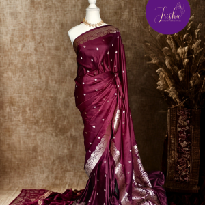 Banarasi Mashru Katan Silk saree in Dark Maroon shade with small buttis all over the saree. The Rose Gold zari makes the finish very royal and elegant. Saree has a very beautiful traditional border and a very rich pallu that makes the usage of this saree suit any occasion or formal wear. The Pallu is attractively designed and woven with intricate Banarasi floral motifs