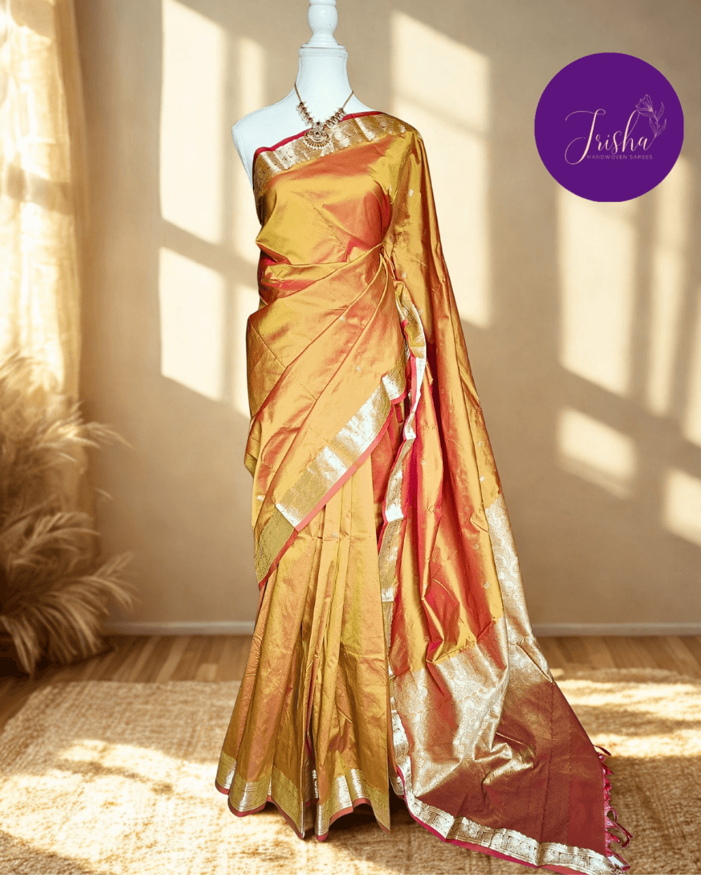 Kanchipuram / Kanjivaram Silk Saree with Gold Zari Border on both sides with traditional Kanchipuram Peacock motifs. Mustard Yellow dual tone with Brick Red selvedge saree with Self Border and Pallu. Traditional Peacock motifs in the border with floral motifs all over pallu. Body of the saree has small floral buttas in two different geometric patterns.